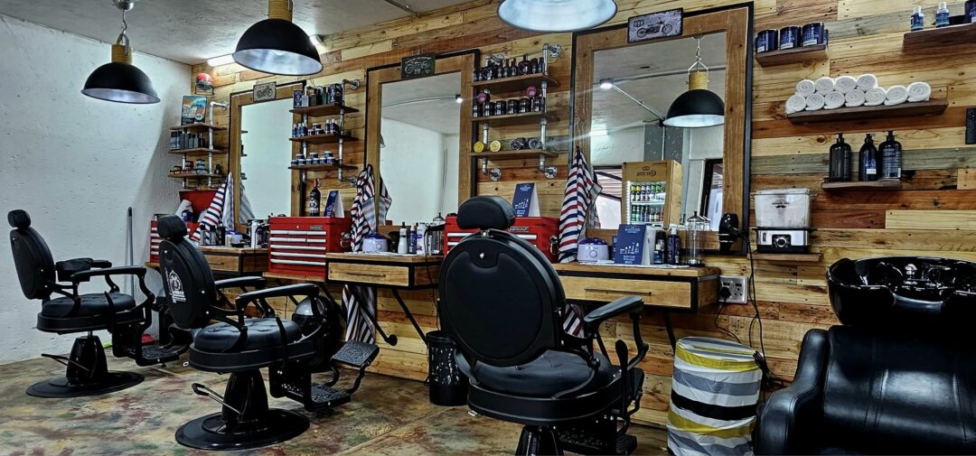 Inside Vo2Max Barber – seating area and product display wall.